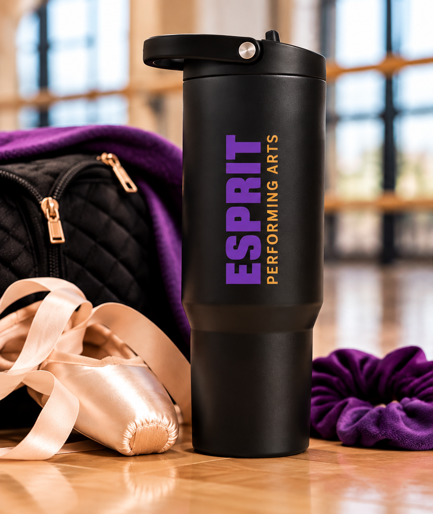 Esprit Performing Arts 32 oz HydroJug with vertical purple and gold logo in dance studio
